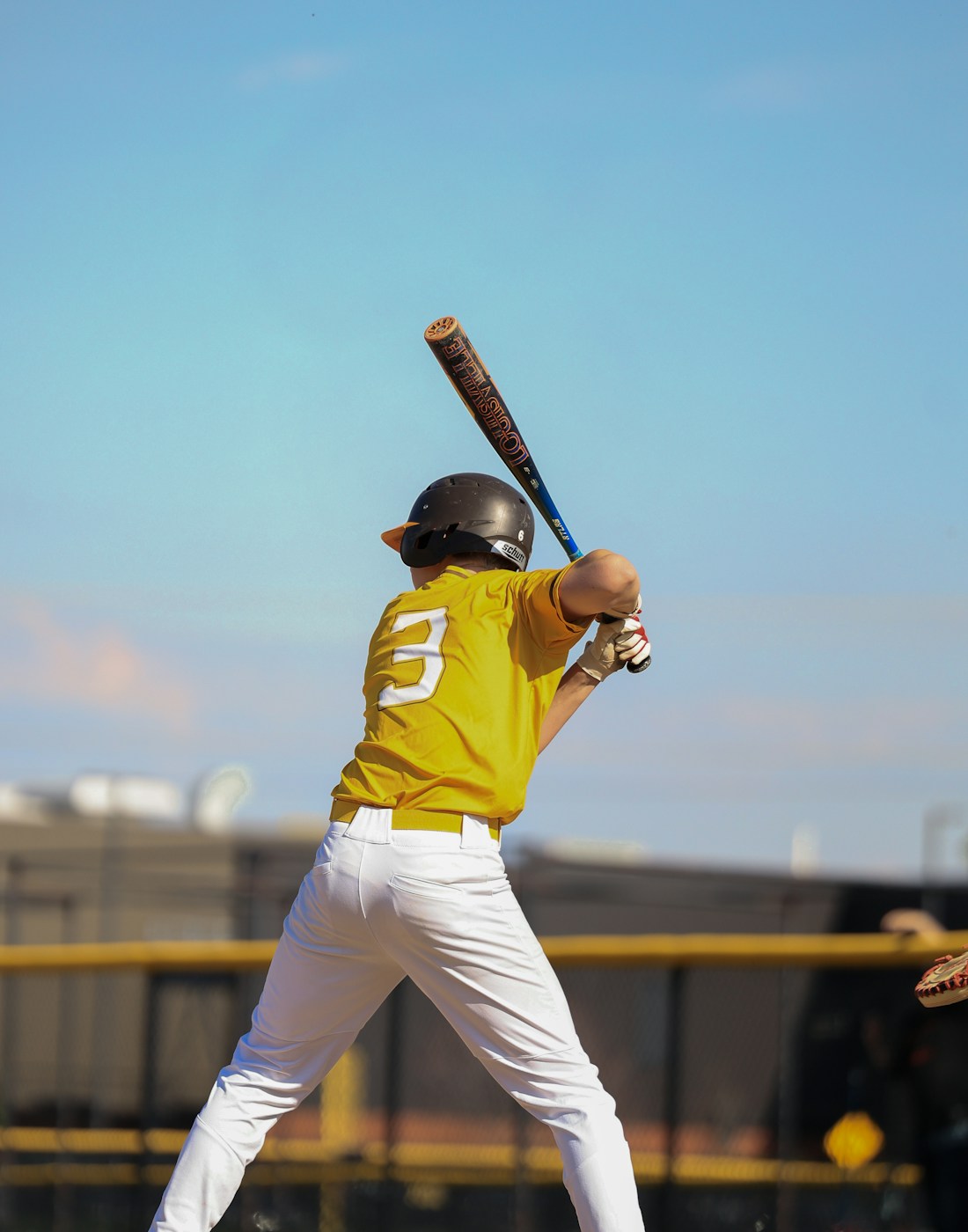 Player gripping a baseball bat fitted with the Homerun Handle