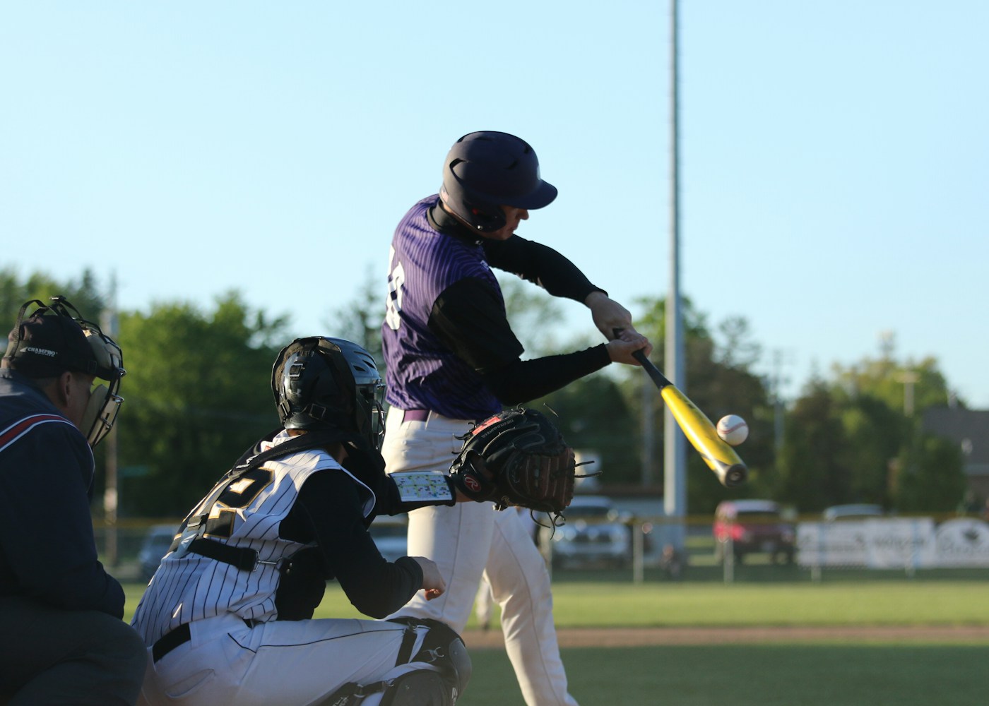 Player hitting off a batting tee